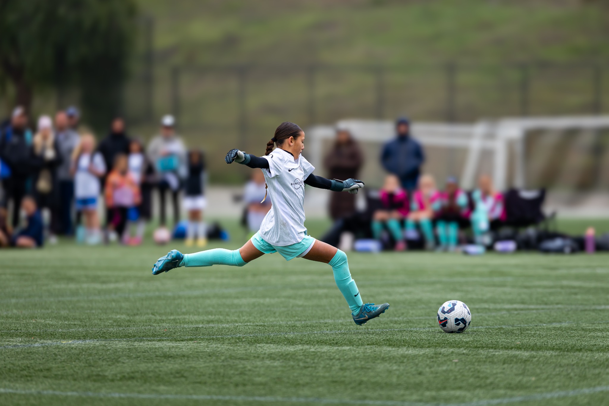 Youth goalkeeper taking a goal kick