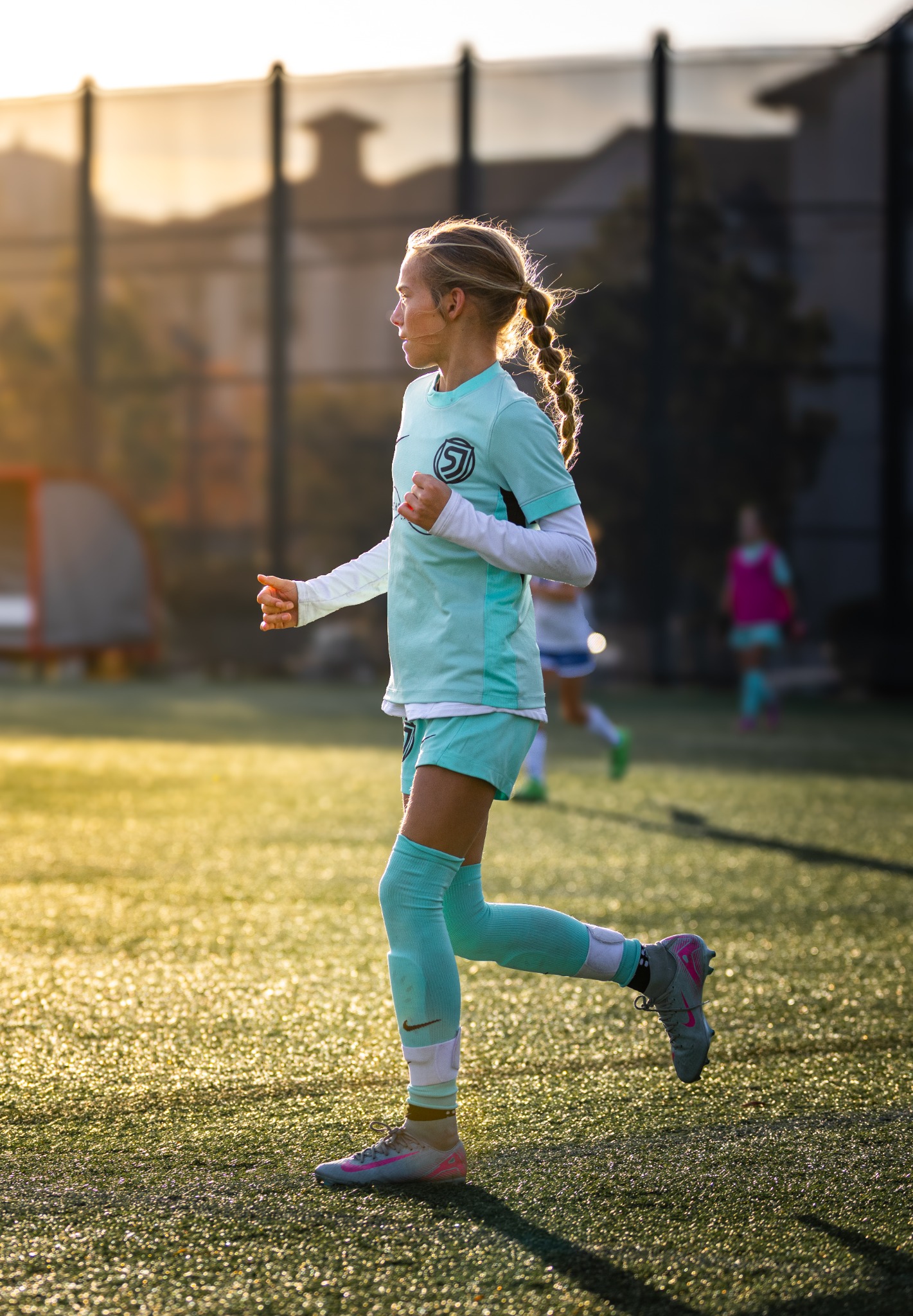San Juan soccer player running through golden backlight