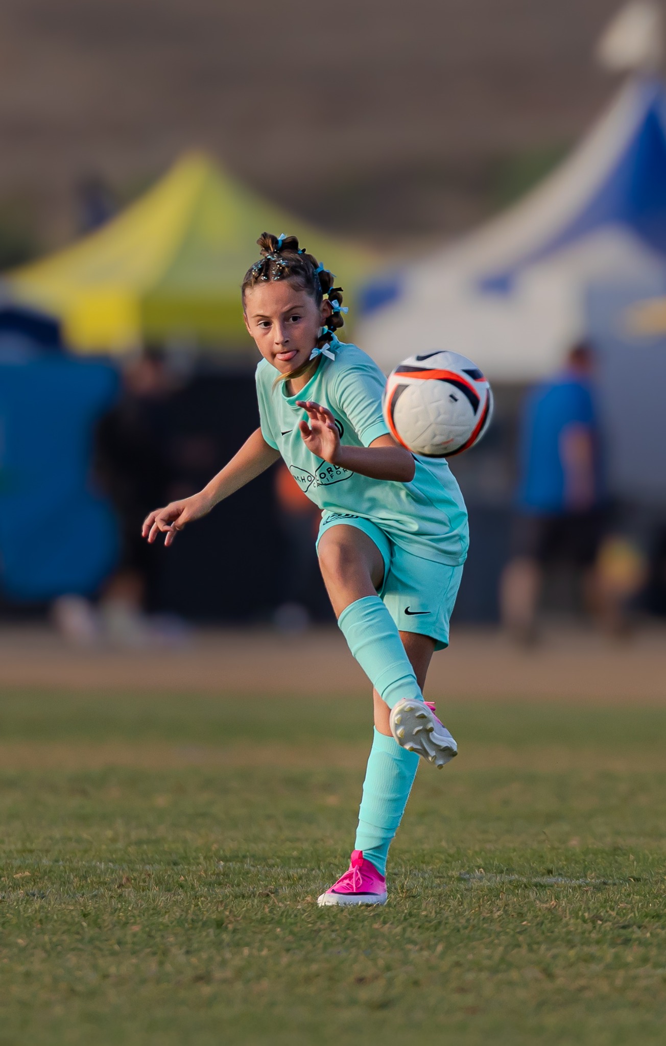 Youth soccer player volleying the ball during a match