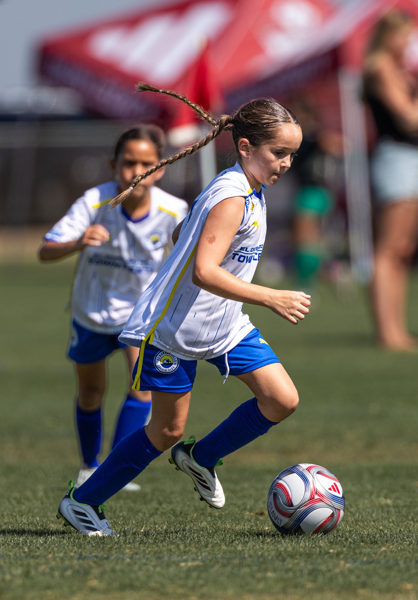 Youth soccer player dribbling during a match