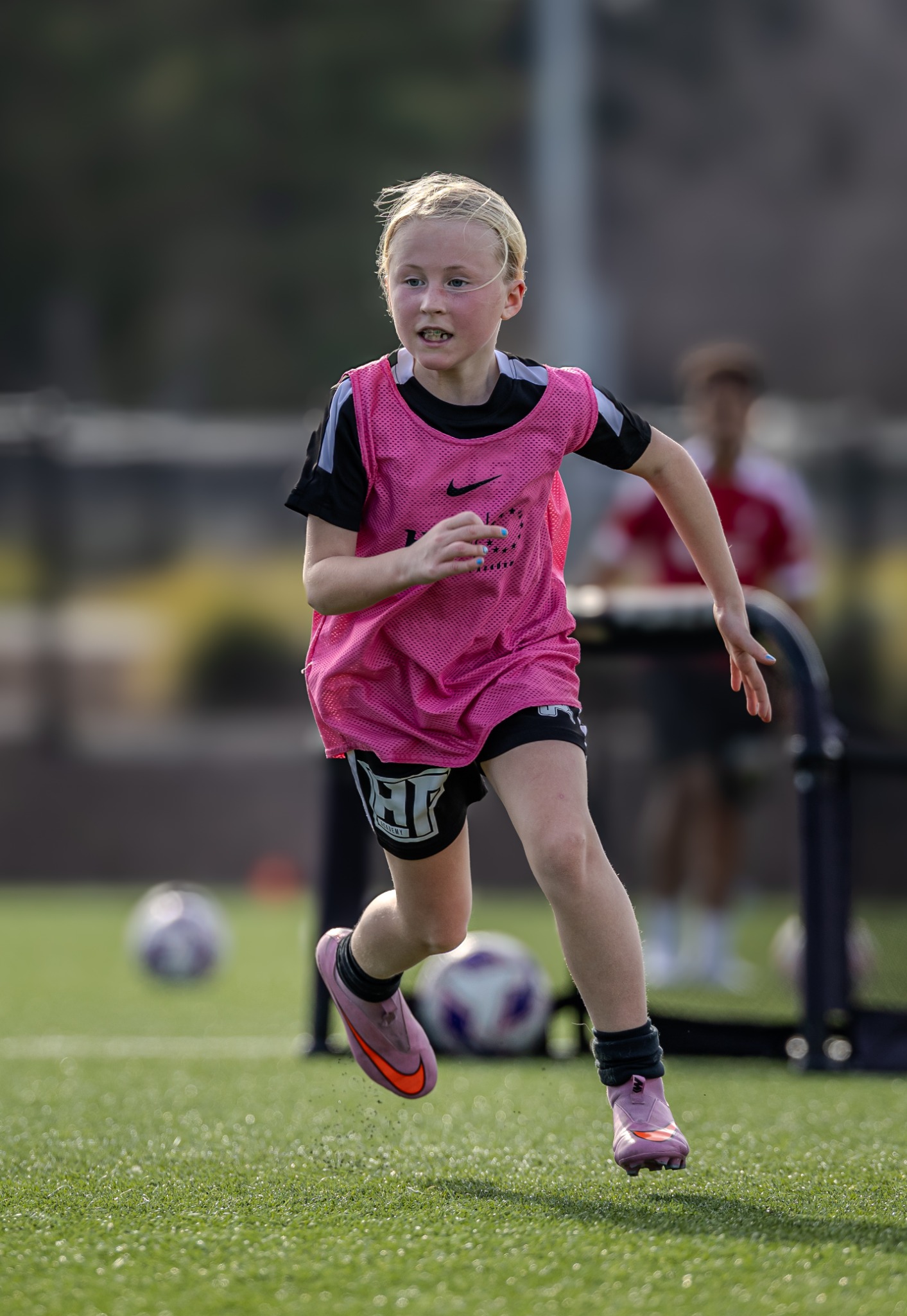 Youth soccer player running during training